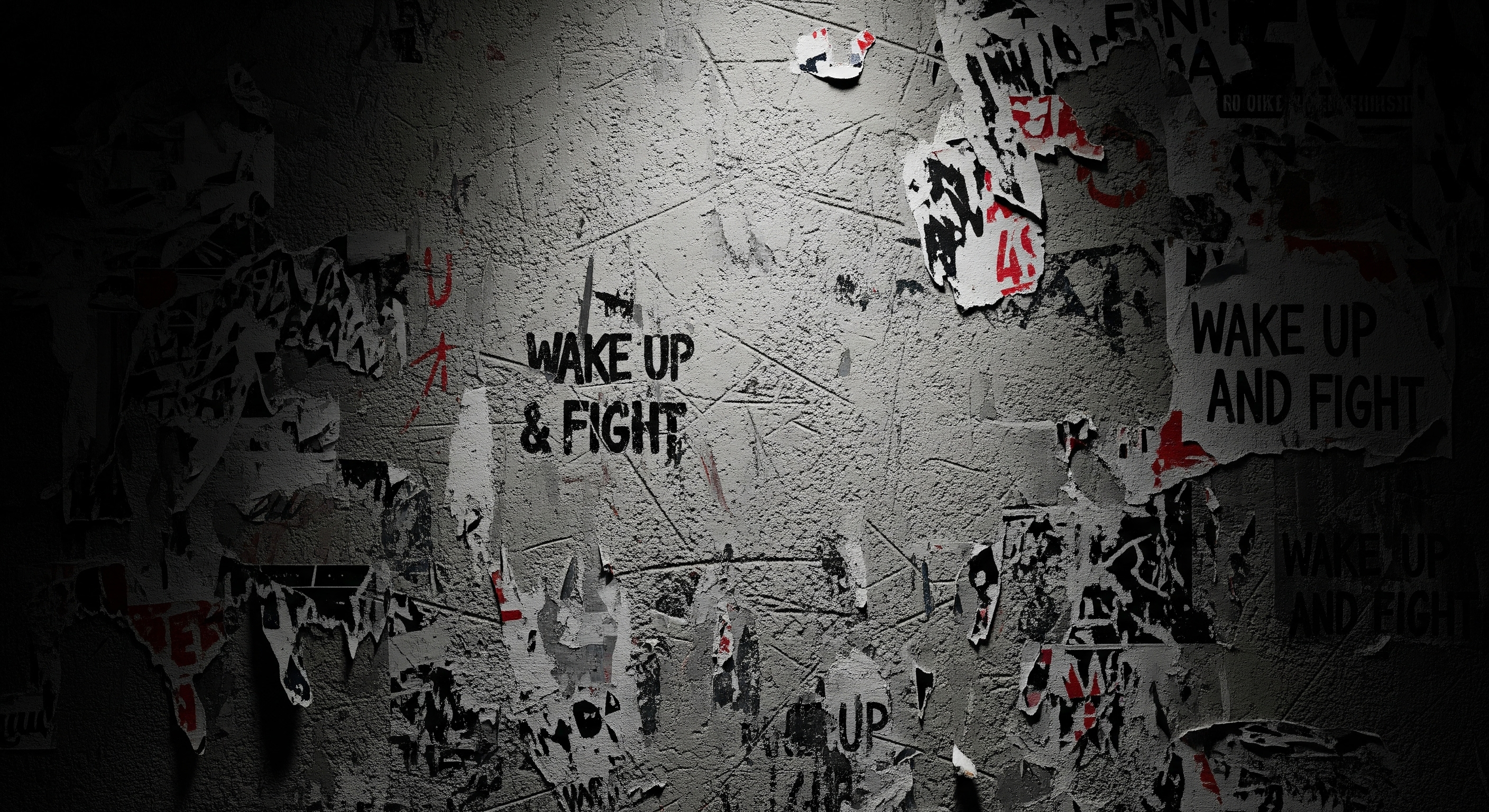 Wall with motivational posters and 'Wake Up & Fight' text in a dark setting